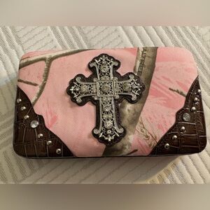 Pink camo clutch wallet with a rhinestone cross embellishment